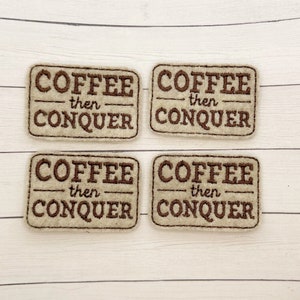 May include: Four beige felt patches with brown embroidery. Each patch reads "Coffee then Conquer".