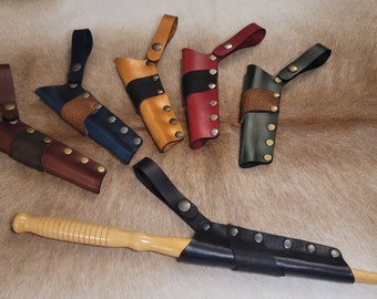 May include: Six leather sheaths with different colored leather and a wooden wand in a black leather sheath.