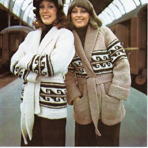 May include: Two women wearing knitted jackets with a geometric pattern. The jackets have a shawl collar and a tie belt. The woman on the left is wearing a white jacket with brown and black accents. The woman on the right is wearing a beige jacket with brown and black accents. The image includes the text "Telegarn" and "5104".