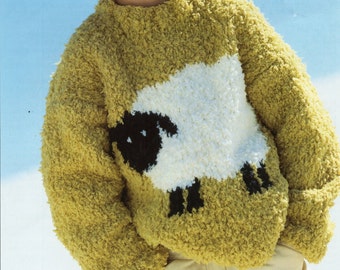 May include: A child wearing a green and white knitted sweater with a sheep design. The sweater has a fluffy texture. The child is wearing a green hat.