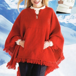 May include: A red knitted poncho with fringe trim and a keyhole neckline. The poncho is worn by a woman with blonde hair and a white shirt underneath.
