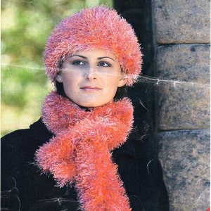 May include: A pink fuzzy knit hat and matching scarf. The hat is a slouchy style with a wide brim. The scarf is long and flowing. The price is 35p.