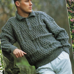 May include: A green tweed sweater with a collared neckline and three buttons. The sweater has a textured knit pattern and a front pocket. The words "For the Great Outdoors" are printed on the left side of the image.