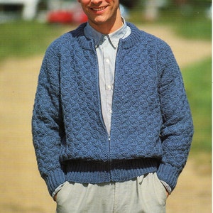 May include: A blue knitted zip-up cardigan with a textured pattern. The cardigan is 91-117 cm (36-46 in) and comes in six sizes. The pattern number is 5000A Chunky.