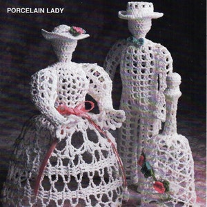 May include: Crochet pattern for a porcelain doll couple and a bell. The dolls are dressed in white crochet with red accents. The pattern is titled "Porcelain Thread" and includes the names "Porcelain Lady", "Porcelain Man", and "Porcelain Bell".