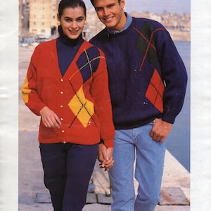 May include: Two people wearing sweaters with a diamond pattern. The sweaters are red, blue, yellow, and green. The text "DOUBLE KNITTING featured in BEEHIVE DK" is at the bottom of the image.