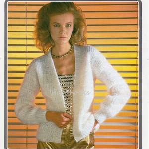 May include: A white mohair cardigan with a V-neck and long sleeves. The cardigan is shown on a model wearing a gold top and trousers. The text "Richard Poppleton 1783 Rio Mohair Type" is printed on the image.