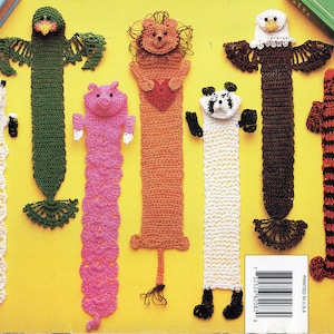 May include: Set of 8 crocheted animal bookmarks. The bookmarks feature a variety of animals including a sheep, a bird, a lion, a pig, a panda, an eagle, a cat, and a dog. The bookmarks are all crocheted in different colors and patterns.