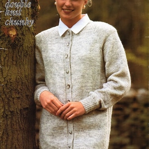 May include: A light grey button-down cardigan with a white collar. The long-sleeved sweater is made of a chunky knit material. The text "4 ply aran double knit chunky" is visible in the upper left corner.