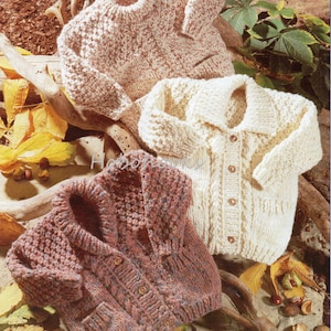 May include: Three knitted cardigans in different colours and patterns. The cardigan on the left is a brown and white speckled cardigan. The cardigan in the middle is a white cardigan with a cable knit pattern. The cardigan on the right is a brown and pink cardigan with a cable knit pattern.