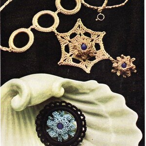 May include: A set of three crocheted necklaces with blue and brown beads. The necklaces are made with a beige yarn and feature a star, circle, and flower design.