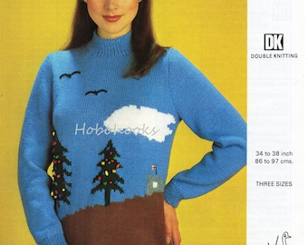 May include: A blue knitted sweater with a landscape design featuring two Christmas trees, a cloud, and a castle. The sweater has a brown lower section and a high neck. The text "Hobehooks" is visible on the sweater.