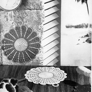 May include: Two crocheted doilies, one in brown and one in white, with a flower-like design. The doilies are shown on a wooden surface.
