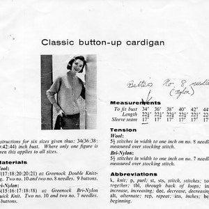 May include: A black and white photo of a woman wearing a button-up cardigan. The image includes instructions for knitting the cardigan in six sizes: 34, 36, 38, 40, 42, and 44 inches. The instructions include materials, tension, and abbreviations.