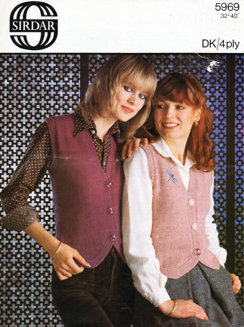 May include: Two women wearing knitted vests. The woman on the left is wearing a purple vest with buttons and a brown and white polka dot shirt. The woman on the right is wearing a pink vest with buttons and a white shirt. Both vests have a V-neckline. The vests are made with DK/4ply yarn. The pattern number is 5969, size 32-40.