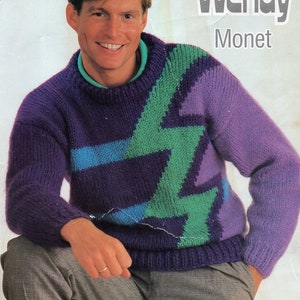 May include: A purple, green, and blue knitted sweater with a lightning bolt design. The sweater is modeled by a person with short brown hair. The text "Wendy Monet" and "2882" are printed on the image.