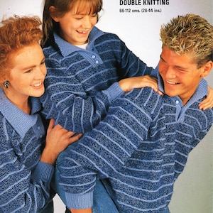 May include: Two people wearing blue and white striped jumpers. The person at the back is holding the person at the front. The text on the image reads "Wool Rich Double Knitting 66-112 cms. (26-44 ins.)"