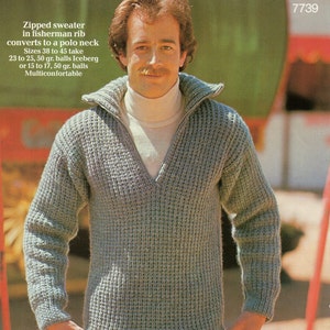 May include: A grey knitted sweater with a zip and a v-neck. The sweater is made with a fisherman rib stitch and can be converted to a polo neck. The text on the image reads: "Zipped sweater in fisherman rib converts to a polo neck Sizes 38 to 45 take 23 to 25, 50 gr. balls Iceberg or 15 to 17, 50 gr. balls Multiconfortable 7739"
