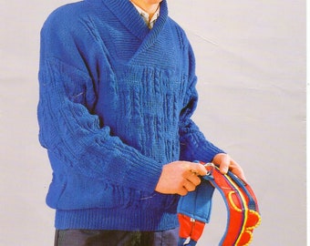 May include: A blue knitted sweater with a wide collar. The sweater has a cable knit pattern. The model is wearing the sweater with a red helmet and a climbing harness.