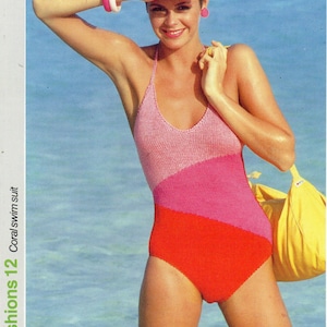 May include: A woman wearing a pink, red, and white striped swimsuit. She is standing in the water and holding a yellow bag.