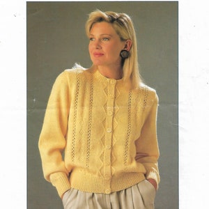 May include: A yellow knitted cardigan with a diamond pattern and button closure. The cardigan is shown on a model with a light background.  High Style C8786 30-40" DK