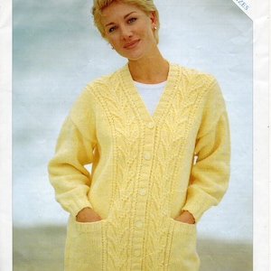May include: A yellow knitted cardigan with a cable knit pattern and pockets. The cardigan has a button-up front and a V-neck.