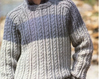 May include: A gray and blue cable knit sweater with a crew neck. The sweater has a horizontal stripe pattern with a light blue stripe in the middle.