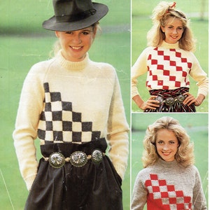 May include: Three women modelling different versions of a knitted sweater with a checkerboard pattern. The sweaters are white with black checkers, red with grey checkers, and grey with red checkers. The sweaters are all long-sleeved and have a high neck.