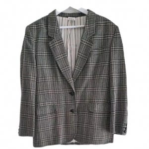 May include: A gray and black plaid blazer with a notched lapel, two front pockets, and a single-button closure. The blazer is hanging on a white hanger against a white background. The interior lining is striped.