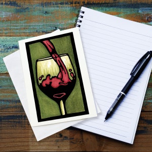 May include: A greeting card with a green background and a red wine glass with wine being poured into it. The glass is outlined in black and the wine is a deep red color.