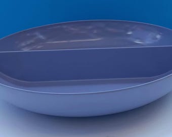 May include: A divided serving bowl made of light blue plastic. The bowl has a rounded shape and a smooth surface.