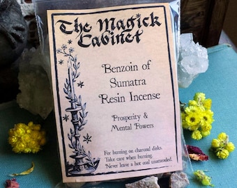 May include: A small bag of Benzoin of Sumatra resin incense. The bag is labeled "The Magick Cabinet" and lists the incense's properties as "Prosperity & Mental Powers".