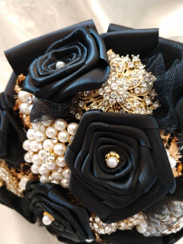 Black and gold brooch hot sale