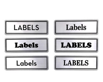 May include: Six silver rectangular labels with black text that reads "LABELS" and "Labels".