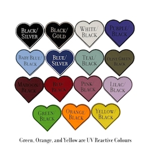 May include: A selection of heart-shaped colour swatches, each displaying a different colour combination and text label. The colours include black/silver, black/gold, white/black, purple/black, baby blue/black, blue/silver, teal/black, olive green/black, maroon/black, red/black, pink/black, lilac/black, green/black, orange/black, and yellow/black. The text at the bottom says "Green, Orange, and Yellow are UV Reactive Colours."