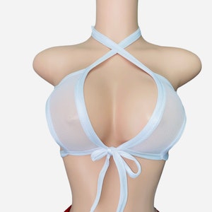 May include: White mesh halter top with a criss-cross design and a tie at the front.