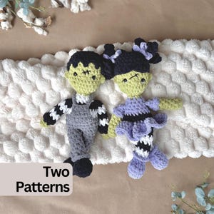 May include: Two crocheted dolls with light green skin and black hair. The left doll wears grey overalls over a black and white striped shirt. The right doll wears a purple dress with a black bodice and striped leggings. Text reads: Two Patterns.