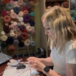 Crochet designer working on handmade amigurumi animal patterns