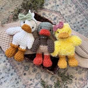 Beginner friendly duck amigurumi pattern showing two finished crochet duck toys