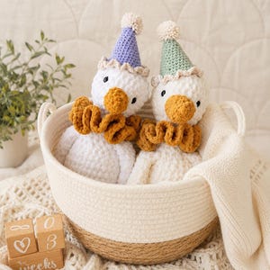 Two crochet party geese displayed in a woven basket with a neutral lifestyle nursery setup.