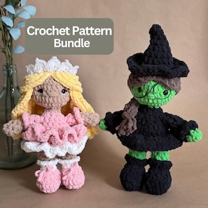 May include: Two crocheted dolls featuring a Crochet Pattern Bundle text overlay. One doll has yellow hair, a white crown, and a pink dress. The other doll has green skin, a black witch hat, black clothing, and round wire-rimmed glasses.