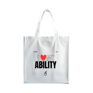 May include: White tote bag with the text "I ❤️ MY ABILITY" in black and red. The bag has a simple design with a heart symbol and a small graphic at the bottom. The bag has two white handles.