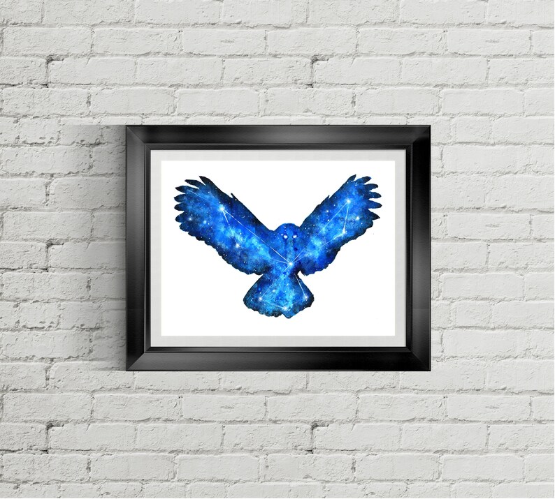May include: A framed print of a blue watercolor owl with a constellation design. The owl is in flight with its wings spread wide.