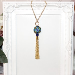 Long gold necklace with blue and green cloisonné enamel focal bead and tassel