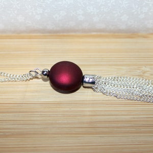 Long silver necklace with burgundy red focal bead and tassel pendant image 3