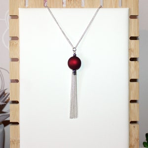 Long silver necklace with burgundy red focal bead and tassel pendant image 1