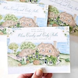 May include: A rectangular save the date card featuring a watercolor illustration of a large house with a brown roof and green vines, set against a blue ocean background. The text reads: Save the date for the wedding of Olivia Crowley and Cody Sedler, July 26, 2024, Beverly, MA.