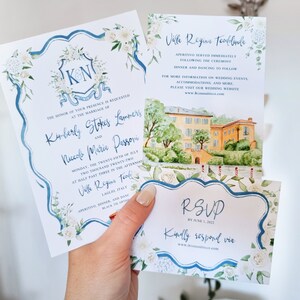May include: Wedding invitation suite with blue and white floral designs. The invitation features the couple's names and wedding date. The RSVP card includes the text "RSVP by June 1, 2022" and "Kindly respond via".