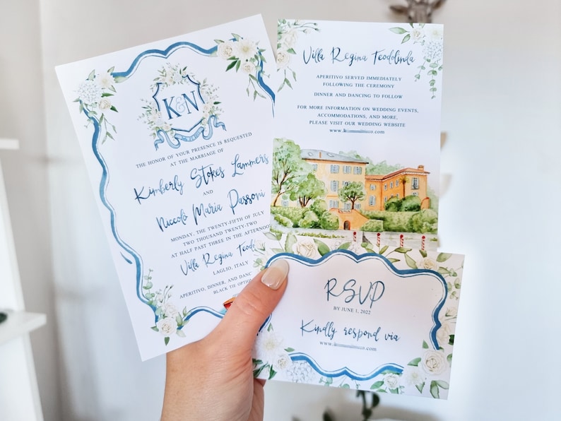 May include: Wedding invitation suite with blue and white floral designs. The invitation features the couple's names and wedding date. The RSVP card includes the text "RSVP by June 1, 2022" and "Kindly respond via".