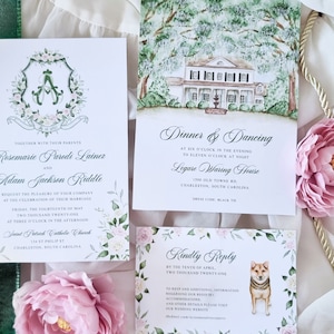 May include: Wedding invitation suite with a watercolor illustration of a house and a floral crest. The invitation includes the names Rosemarie Parodi Lainer and Adam Jackson Riddle, the date Friday, the fourteenth of May, two thousand twenty-one, and the time three o'clock in the afternoon. The invitation also includes the location Saint Patrick Catholic Church, 158 East Philip St, Charleston, South Carolina. The reception information includes the time six o'clock in the evening to eleven o'clock at night, the location Ligare Waring House, 1500 Old Towne Rd, Charleston, South Carolina, and the dress code black tie. The RSVP card includes the date by the tenth of April, two thousand twenty-one.